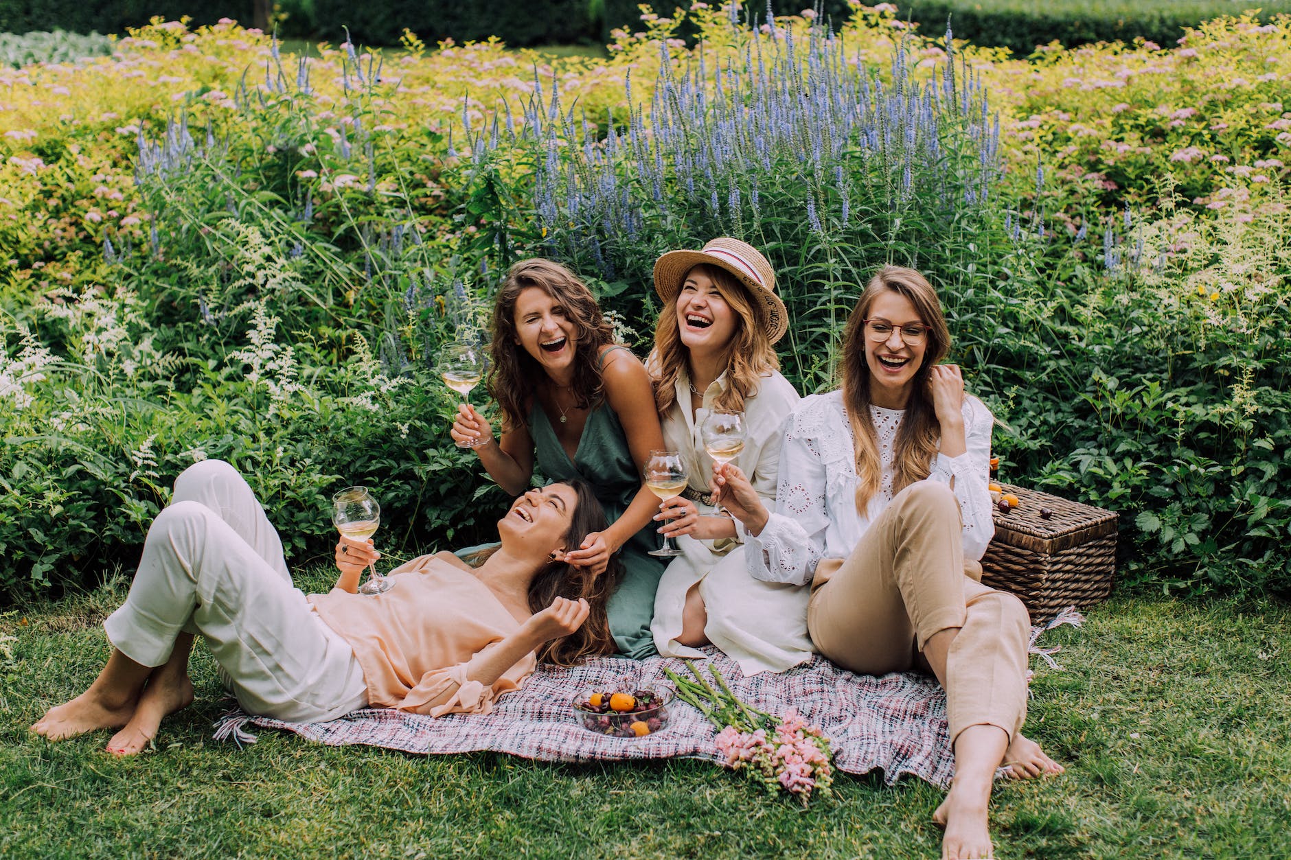 women sitting on green grass field